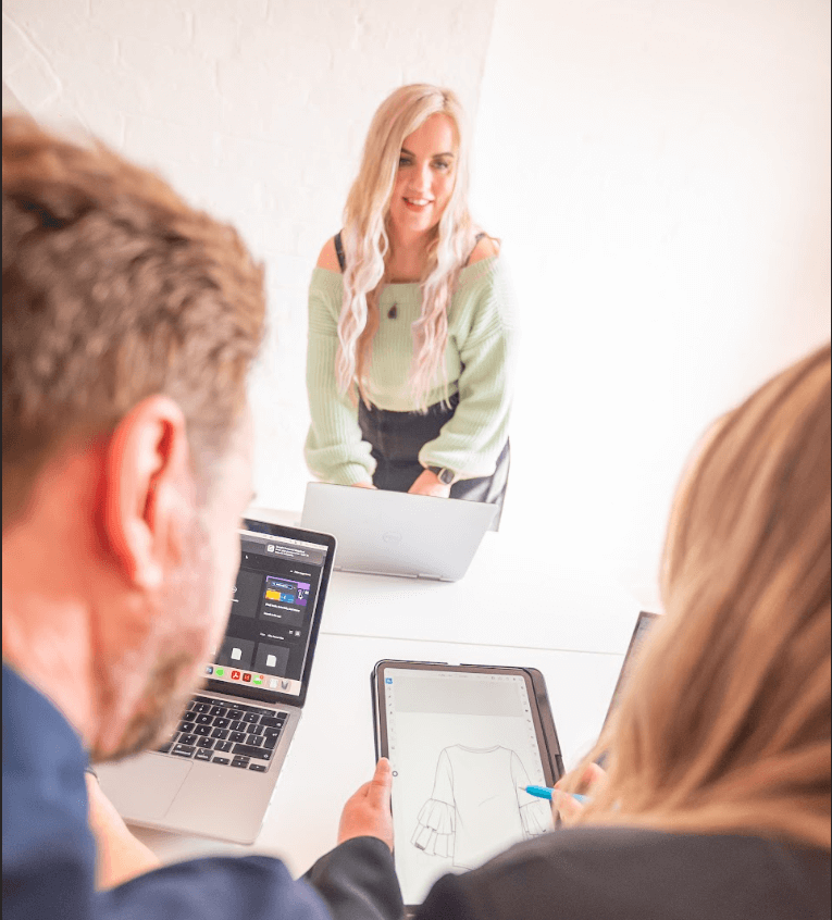 Laura Fish leading a digital fashion skills session in a classroom, supporting students with hands-on CLO3D training