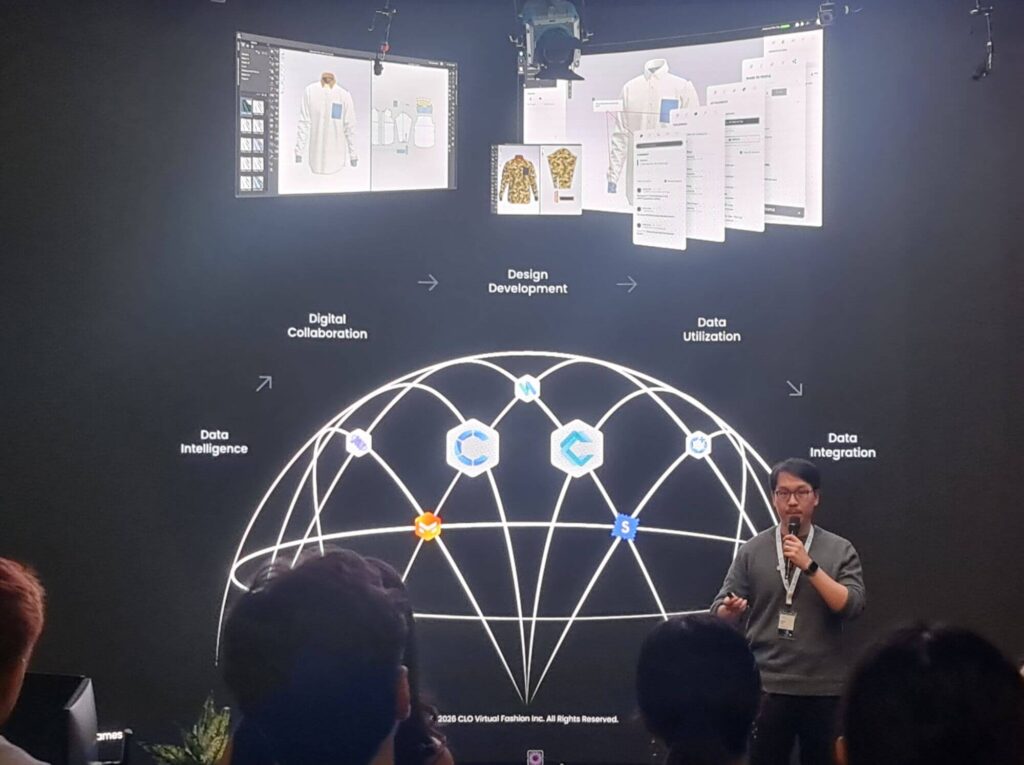 Brian King presenting at a CLO x Epic Games event in London, with a large slide showing a connected digital workflow across design, data, and collaboration